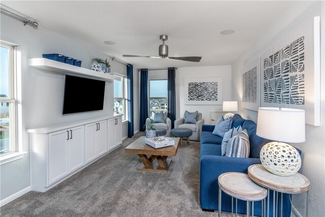 living room featuring plenty of natural light, ceiling fan, and carpet floors