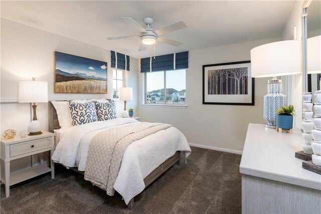 bedroom featuring ceiling fan and dark carpet