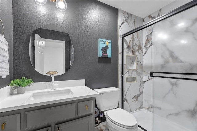 bathroom featuring toilet, vanity, and walk in shower