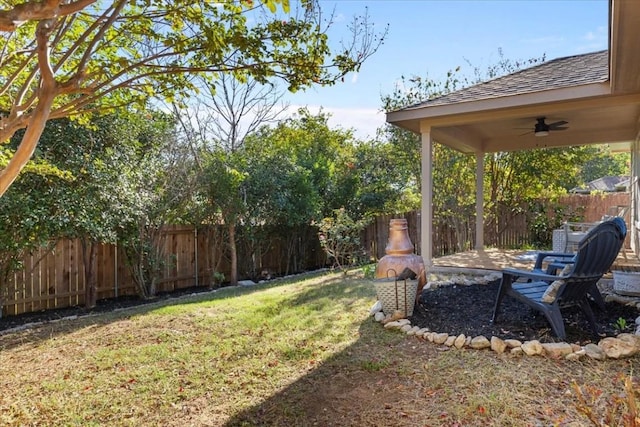 view of yard with ceiling fan and a patio