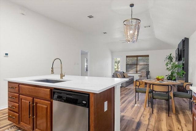 kitchen featuring hardwood / wood-style floors, a center island with sink, stainless steel dishwasher, and sink