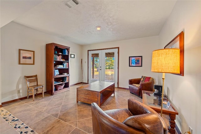 interior space with french doors, a textured ceiling, and tile patterned floors