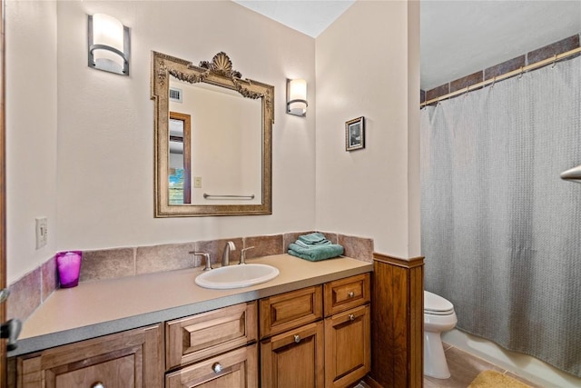 bathroom featuring walk in shower, vanity, and toilet