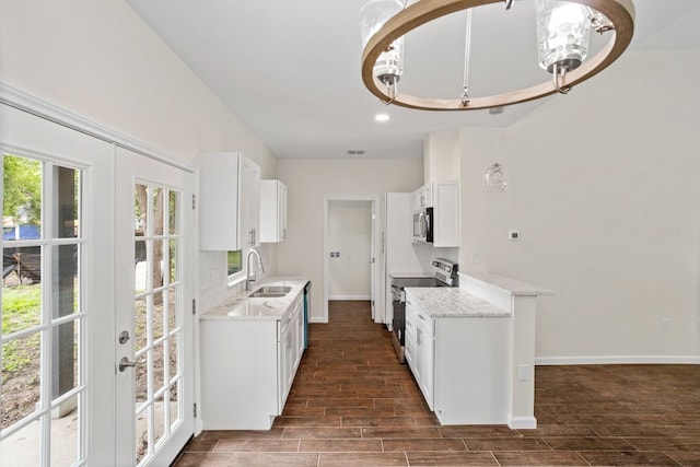 kitchen featuring french doors, dark hardwood / wood-style flooring, stainless steel appliances, sink, and white cabinetry