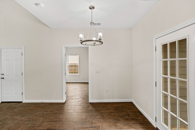 unfurnished dining area with dark wood-type flooring and a notable chandelier