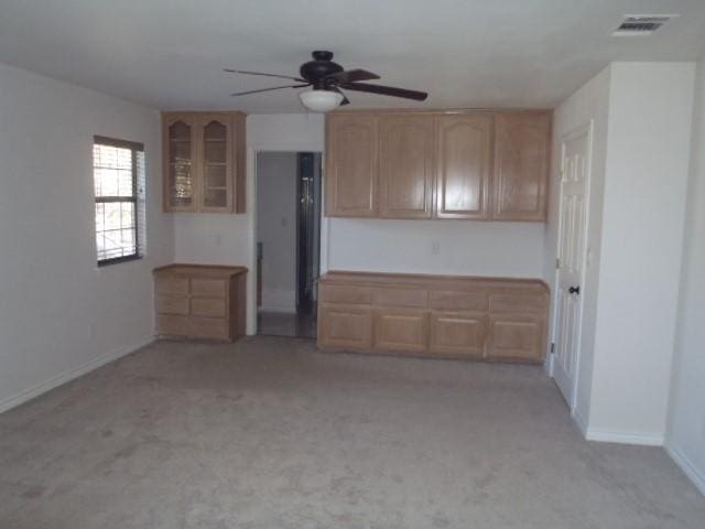 unfurnished living room with light carpet and ceiling fan