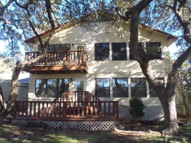 back of property featuring a wooden deck and a balcony