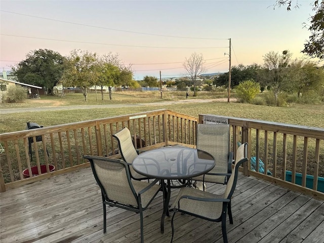 deck at dusk with a lawn