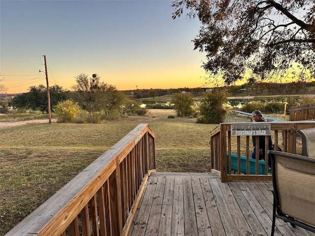 deck at dusk with a lawn