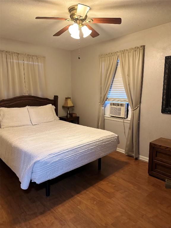 bedroom with hardwood / wood-style floors and ceiling fan