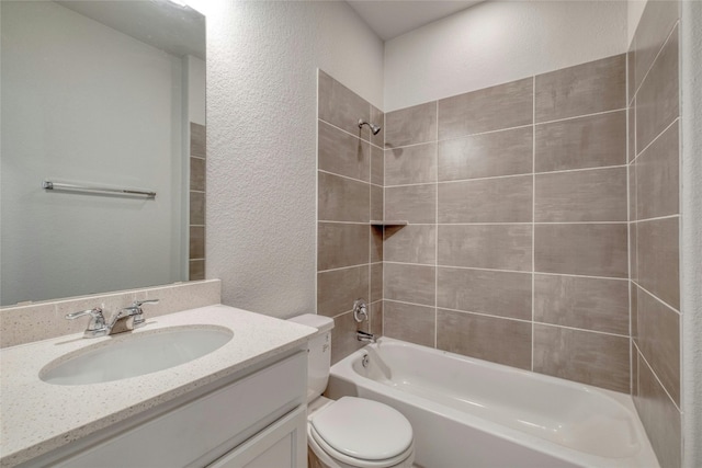 full bathroom with tiled shower / bath combo, toilet, and vanity