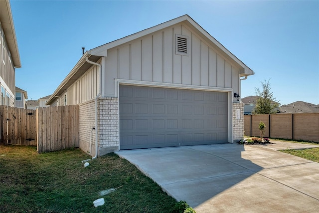 12101 Corsicana Trl, Manor, TX 78653 - view of front of home featuring brick siding, board and batten siding, a garage, and driveway