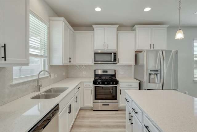 12101 Corsicana Trl, Manor, TX 78653 - kitchen with stainless steel appliances, white cabinetry, light stone counters, recessed lighting, and decorative backsplash