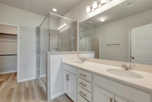 bathroom featuring vanity, an enclosed shower, and hardwood / wood-style flooring