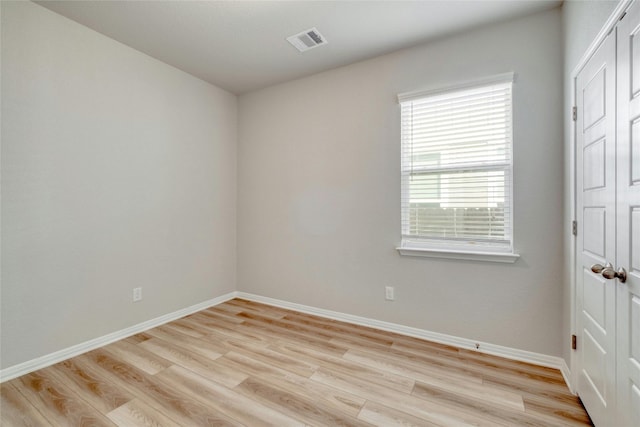 spare room with light wood-type flooring