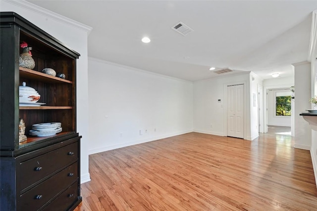 living room with ornamental molding and light hardwood / wood-style flooring