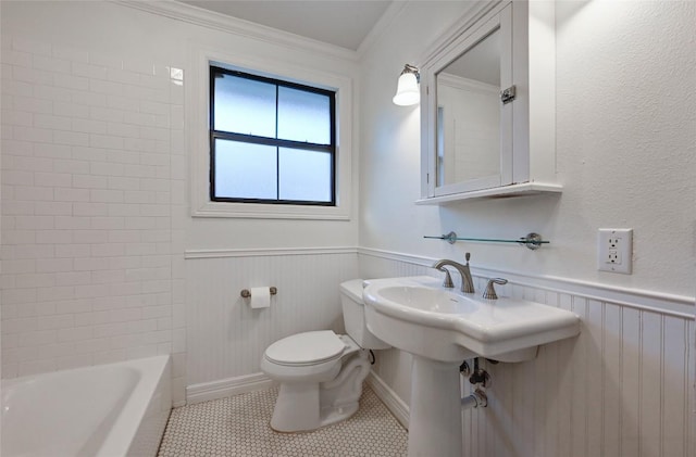 bathroom featuring toilet, a tub to relax in, tile patterned floors, and crown molding