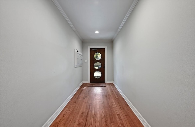 entryway featuring wood-type flooring and ornamental molding