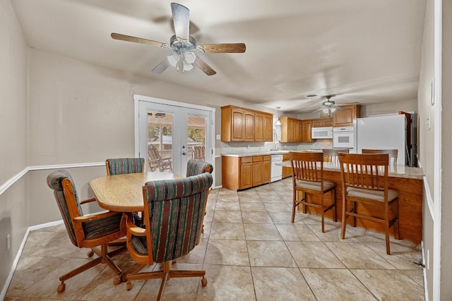 dining room with ceiling fan, french doors, light tile patterned floors, and sink