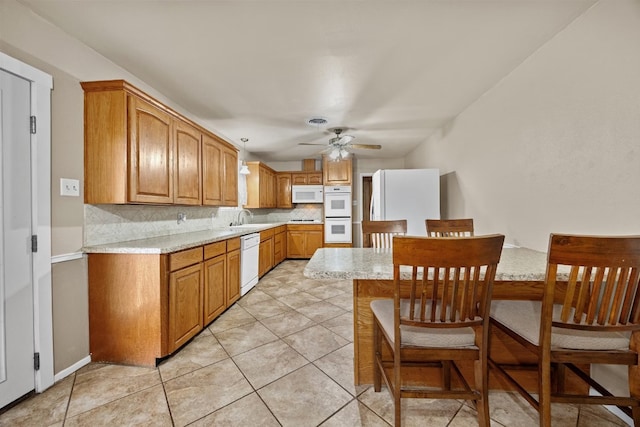 kitchen with ceiling fan, sink, backsplash, white appliances, and light tile patterned floors