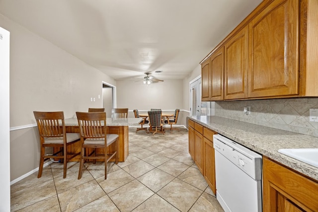 kitchen featuring dishwasher, backsplash, ceiling fan, and light tile patterned flooring