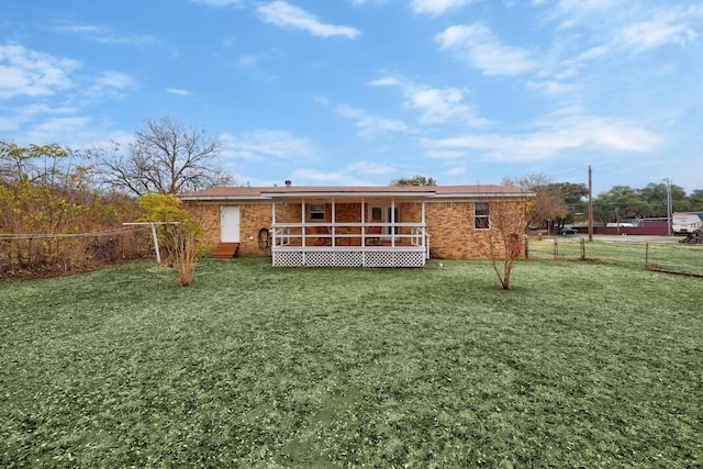 back of house with a lawn