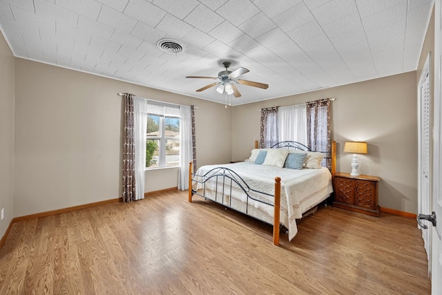 bedroom with ceiling fan and light hardwood / wood-style flooring