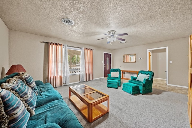 carpeted living room with a textured ceiling and ceiling fan