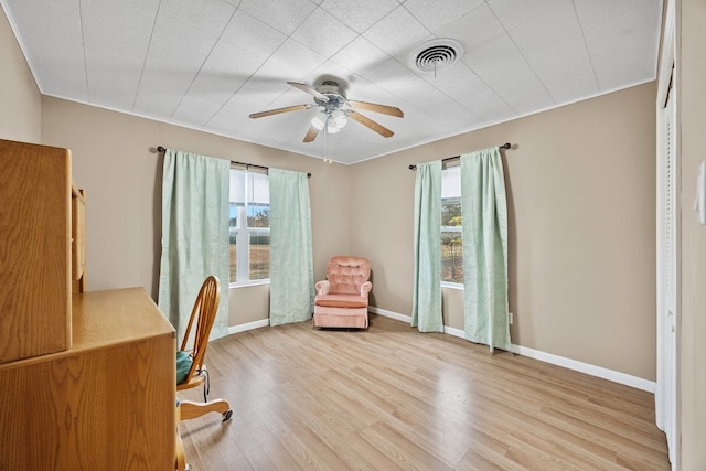 unfurnished office featuring crown molding, ceiling fan, and light hardwood / wood-style floors