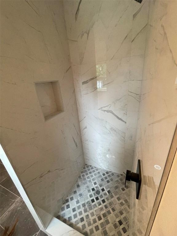 bathroom with a tile shower