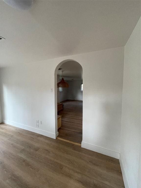 unfurnished room with dark wood-type flooring