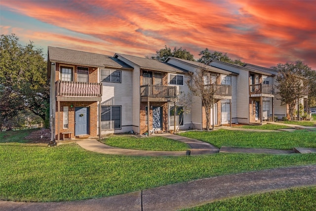 1815 River Crossing Cir Unit D, Austin, TX 78741 - multi unit property featuring a balcony, a lawn, and brick siding