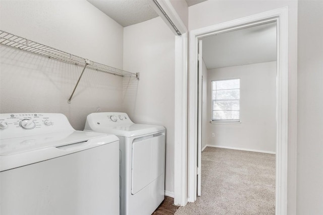 laundry room featuring carpet, washing machine and dryer, laundry area, and baseboards