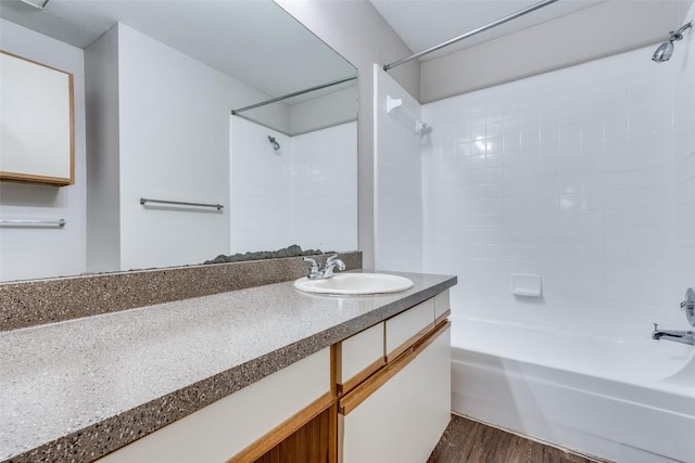 full bathroom featuring shower / bathing tub combination, wood finished floors, and vanity