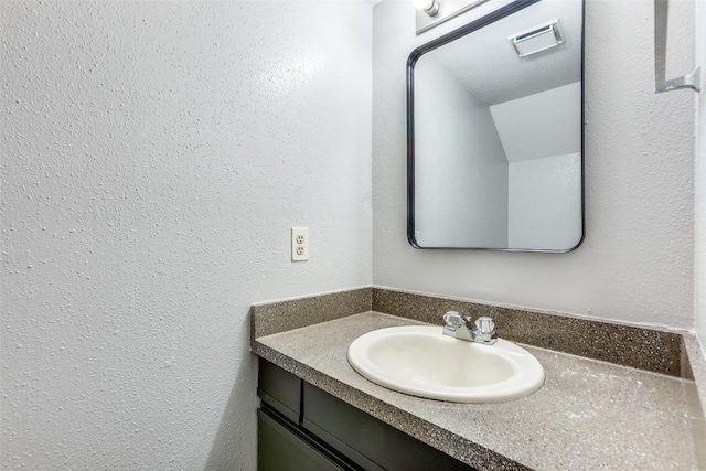 1815 River Crossing Cir Unit D, Austin, TX 78741 - bathroom featuring vanity and a textured wall