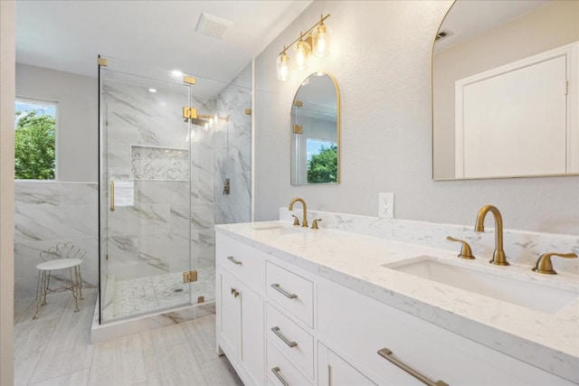 bathroom featuring vanity and a shower with door