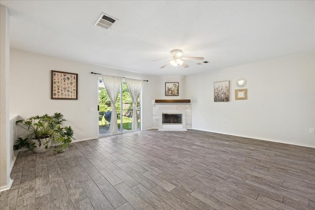 unfurnished living room with a fireplace, hardwood / wood-style flooring, and ceiling fan