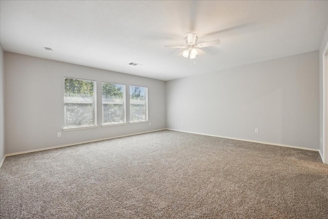 unfurnished room with carpet flooring and ceiling fan