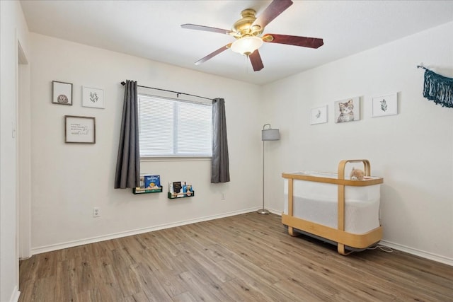 interior space with wood-type flooring and ceiling fan