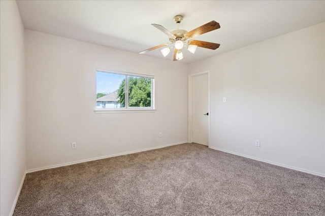 empty room with ceiling fan and carpet floors