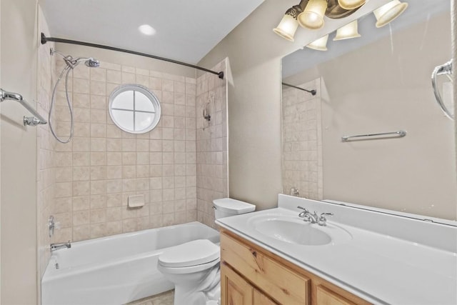 full bathroom with vanity, toilet, and tiled shower / bath combo