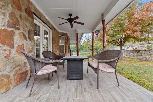 view of patio / terrace with a fire pit and ceiling fan