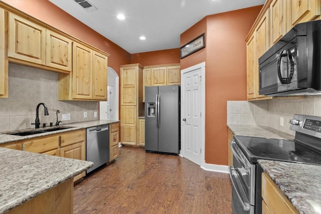 kitchen with dark hardwood / wood-style flooring, sink, light brown cabinets, and appliances with stainless steel finishes