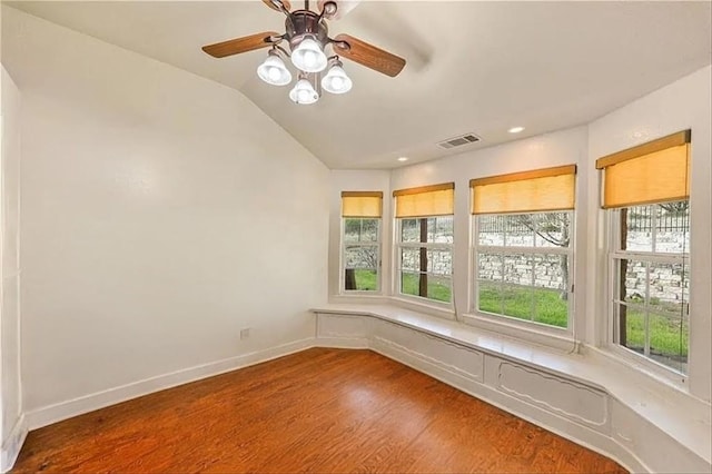 empty room with lofted ceiling and wood-type flooring