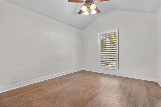 empty room featuring ceiling fan, vaulted ceiling, and hardwood / wood-style flooring