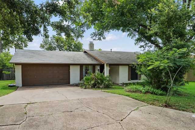 view of front of home with brick siding, an attached garage, and concrete driveway