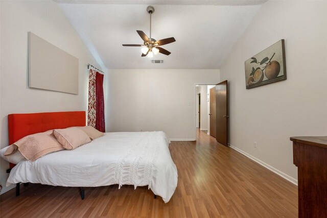 bedroom featuring hardwood / wood-style floors, ceiling fan, and lofted ceiling