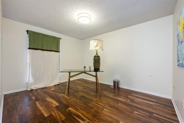 interior space with dark hardwood / wood-style floors and a textured ceiling