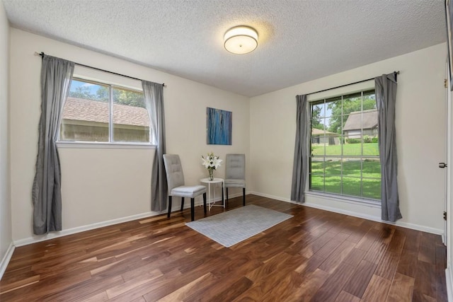 unfurnished room featuring a textured ceiling and dark hardwood / wood-style floors