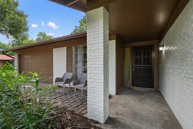 doorway to property with a garage